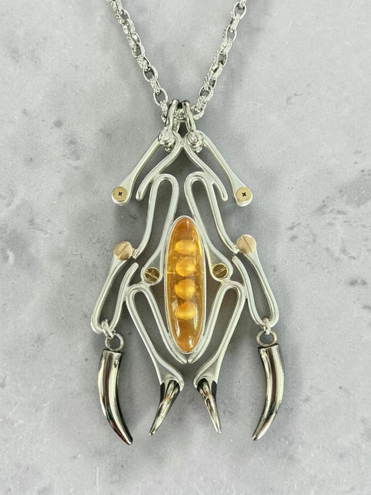 ‘Alakdan’ neckpiece is inspired by the Philippine scorpion. Created with welded brass hooks and accented with a vintage glass stone.