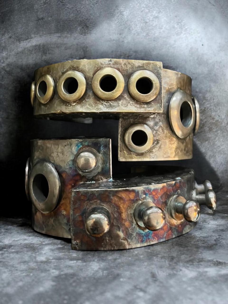 Sculptural modular cuffs in oxidized and distressed brass and bronze finishes. These cuffs interlock when worn.