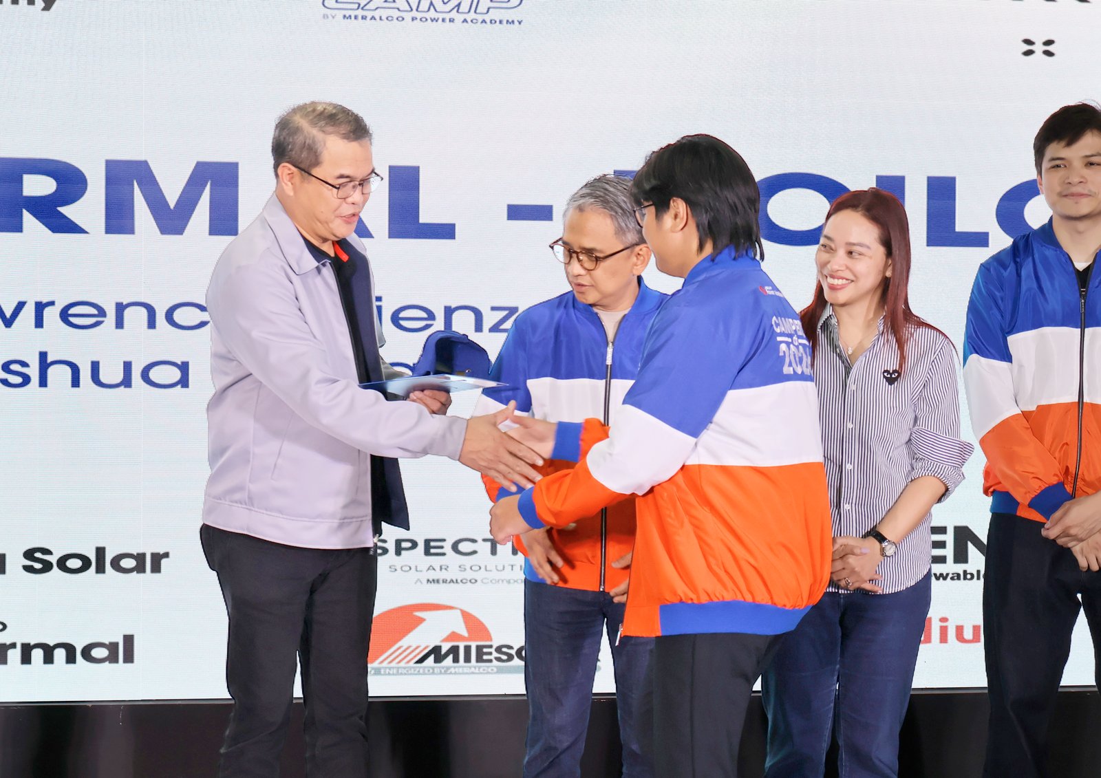 PowerCamp graduates were recognized by Meralco executives led by Meralco Power Academy president and Meralco executive vice president and chief operating officer Ronnie L. Aperocho (leftmost).