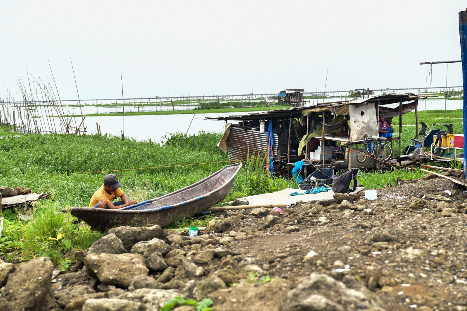 Fisherman Eddy Casin, 46, stands near his makeshift home beside the Lakeshore Complex in Taguig City on 5 September. Casin said the nearby reclamation project has hurt his livelihood, making it harder to earn from fishing and meet his daily needs. | Zedrich Xylak Madrid