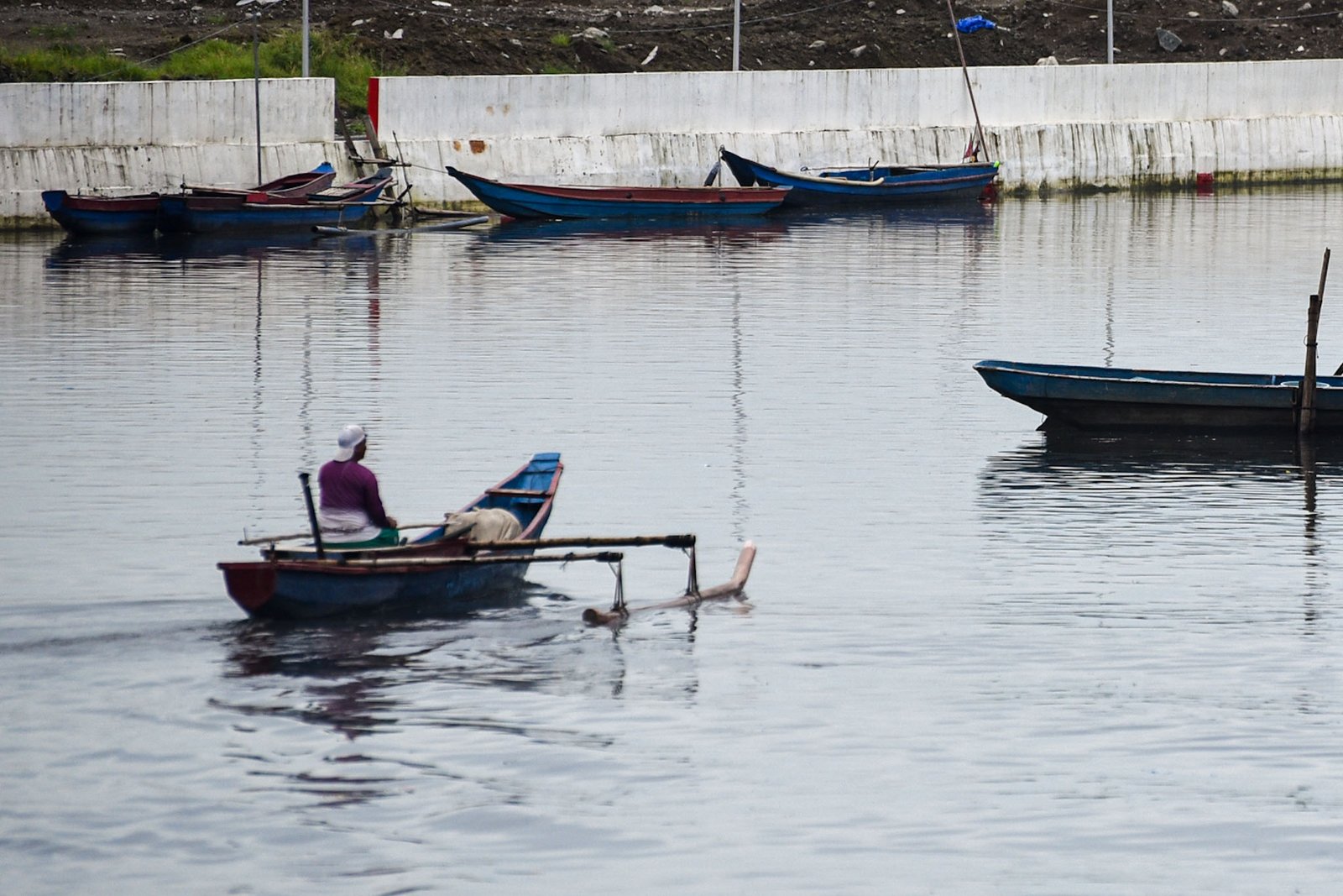 Fisherman Eddy Casin, 46, stands near his makeshift home beside the Lakeshore Complex in Taguig City on 5 September. Casin said the nearby reclamation project has hurt his livelihood, making it harder to earn from fishing and meet his daily needs. | Zedrich Xylak Madrid