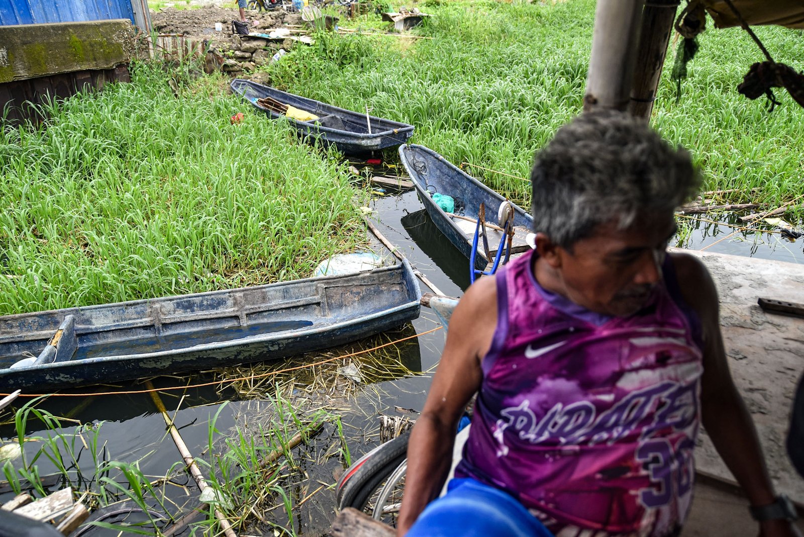 Fisherman Eddy Casin, 46, stands near his makeshift home beside the Lakeshore Complex in Taguig City on 5 September. Casin said the nearby reclamation project has hurt his livelihood, making it harder to earn from fishing and meet his daily needs. | Zedrich Xylak Madrid