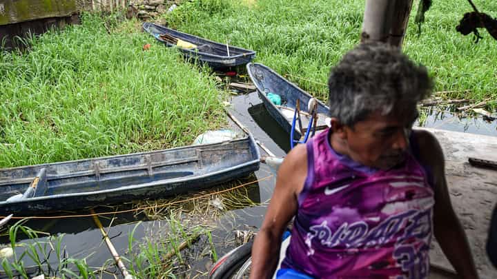 Fisherman Eddy Casin, 46, stands near his makeshift home beside the Lakeshore Complex in Taguig City on 5 September. Casin said the nearby reclamation project has hurt his livelihood, making it harder to earn from fishing and meet his daily needs.