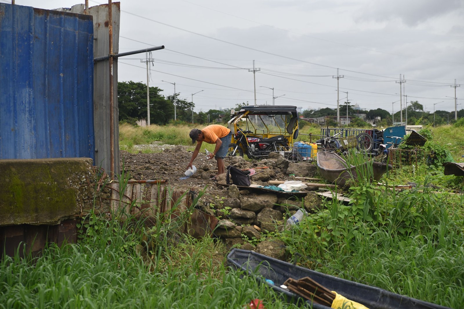 Fisherman Eddy Casin, 46, stands near his makeshift home beside the Lakeshore Complex in Taguig City on 5 September. Casin said the nearby reclamation project has hurt his livelihood, making it harder to earn from fishing and meet his daily needs. | Zedrich Xylak Madrid