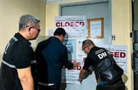 DMW personnel padlock Anecon Tourism Consultancy in Pasig City after the firm was found operating without a license to recruit overseas workers.