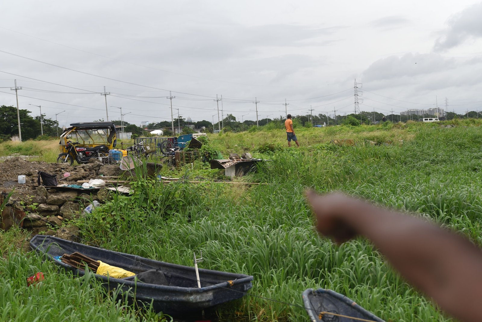 Fisherman Eddy Casin, 46, stands near his makeshift home beside the Lakeshore Complex in Taguig City on 5 September. Casin said the nearby reclamation project has hurt his livelihood, making it harder to earn from fishing and meet his daily needs. | Zedrich Xylak Madrid