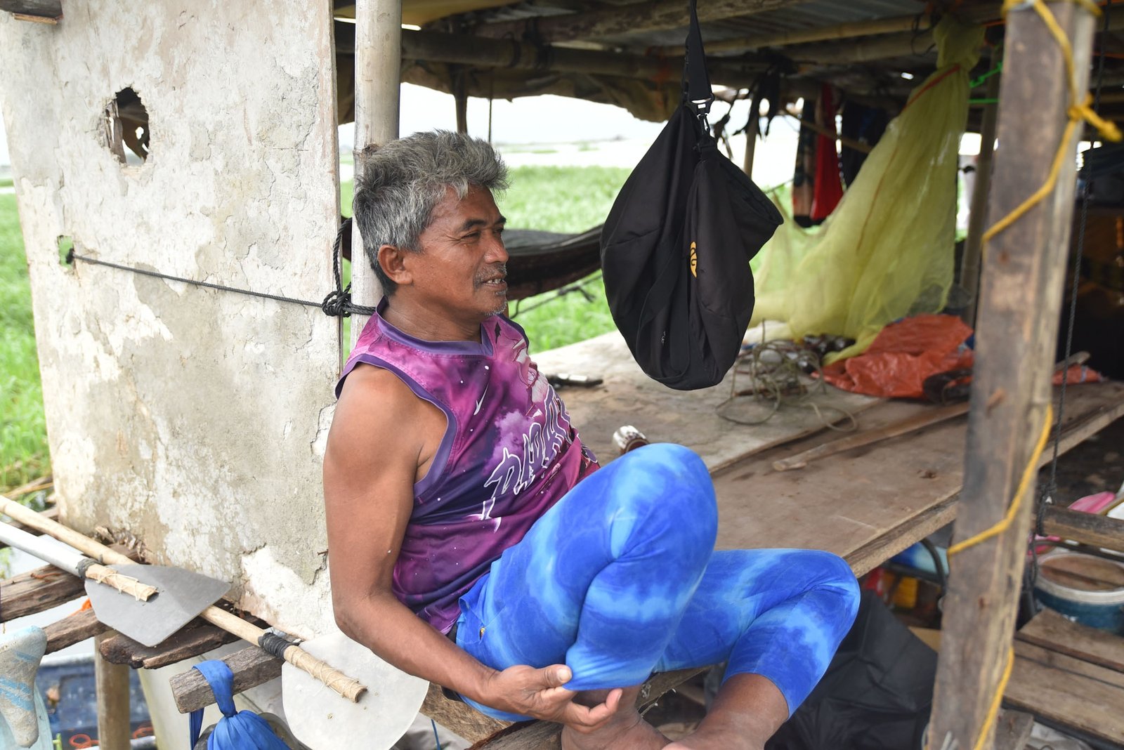 Fisherman Eddy Casin, 46, stands near his makeshift home beside the Lakeshore Complex in Taguig City on 5 September. Casin said the nearby reclamation project has hurt his livelihood, making it harder to earn from fishing and meet his daily needs. | Zedrich Xylak Madrid