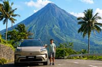 DRIVER Romel Emperado pauses along an open road beside Mayon Volcano during his 1,492-kilometer journey across three major island regions.