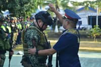 POLICE officers receive a blessing during a send-off ceremony Monday at Camp Col. Rafael C. Rodriguez in Libertad, Butuan City, as PRO 13 deploys 887 personnel to BARMM to augment security forces for the 14 September parliamentary elections.