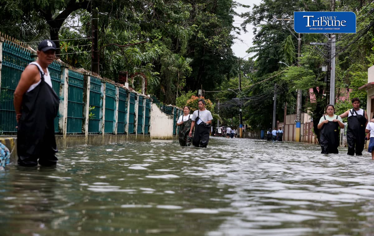 GEARING UP AGAINST FLOOD RISKS

Residents of Barangay San Juan in Hagonoy, Bulacan, wear protective gear while wading through floodwaters on Tuesday, 8 September 2026, in an effort to reduce their exposure to leptospirosis and other health risks.

The barangay has remained flooded for about a month due to persistent monsoon rains.

Photo by Analy Labor