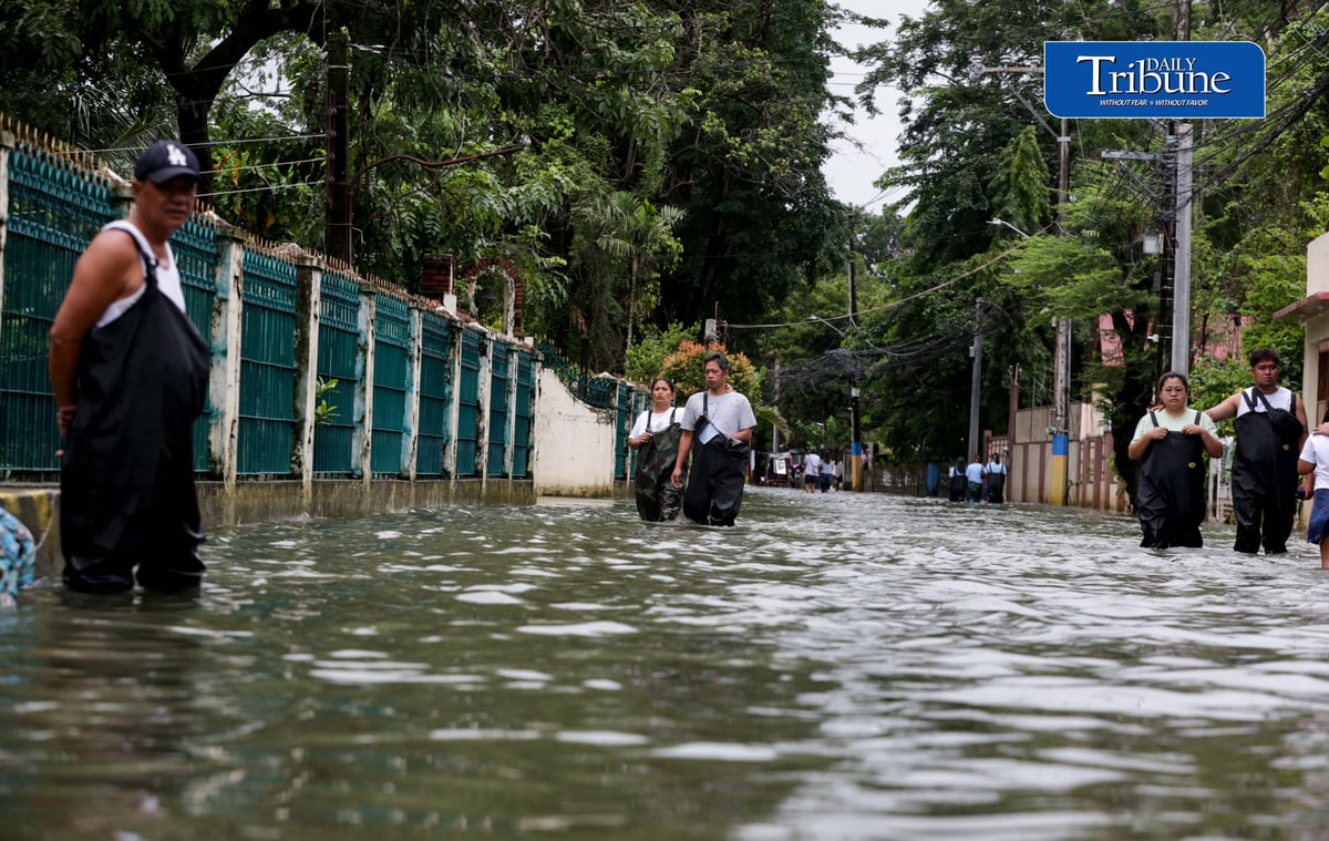 GEARING UP AGAINST FLOOD RISKS

Residents of Barangay San Juan in Hagonoy, Bulacan, wear protective gear while wading through floodwaters on Tuesday, 8 September 2026, in an effort to reduce their exposure to leptospirosis and other health risks.

The barangay has remained flooded for about a month due to persistent monsoon rains.

Photo by Analy Labor