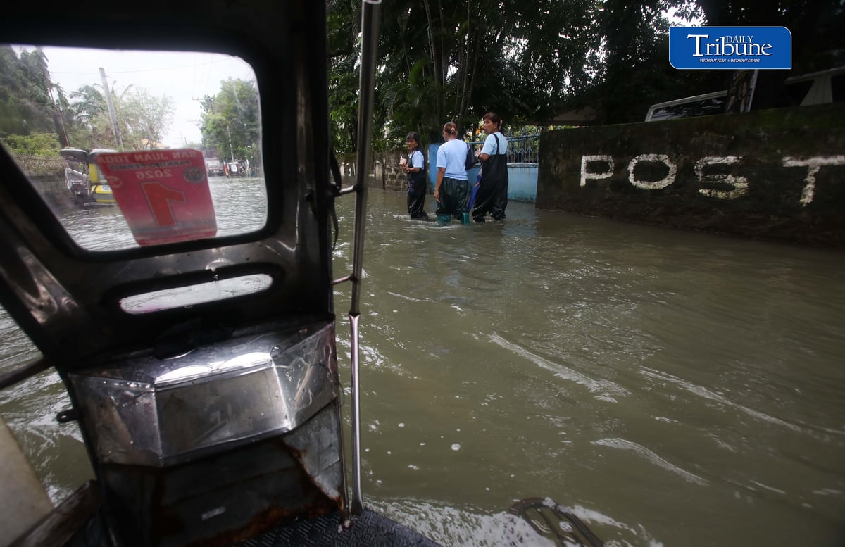 GEARING UP AGAINST FLOOD RISKS

Residents of Barangay San Juan in Hagonoy, Bulacan, wear protective gear while wading through floodwaters on Tuesday, 8 September 2026, in an effort to reduce their exposure to leptospirosis and other health risks.

The barangay has remained flooded for about a month due to persistent monsoon rains.

Photo by Analy Labor