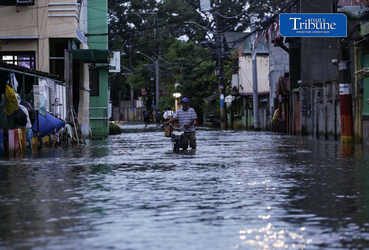 GEARING UP AGAINST FLOOD RISKS

Residents of Barangay San Juan in Hagonoy, Bulacan, wear protective gear while wading through floodwaters on Tuesday, 8 September 2026, in an effort to reduce their exposure to leptospirosis and other health risks.

The barangay has remained flooded for about a month due to persistent monsoon rains.

Photo by Analy Labor
