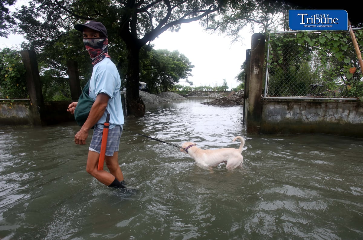 GEARING UP AGAINST FLOOD RISKS

Residents of Barangay San Juan in Hagonoy, Bulacan, wear protective gear while wading through floodwaters on Tuesday, 8 September 2026, in an effort to reduce their exposure to leptospirosis and other health risks.

The barangay has remained flooded for about a month due to persistent monsoon rains.

Photo by Analy Labor