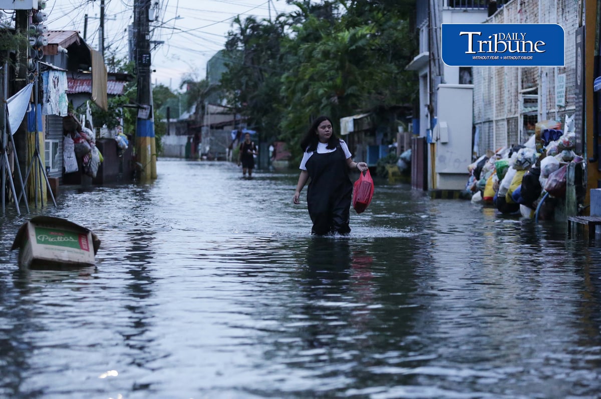 GEARING UP AGAINST FLOOD RISKS

Residents of Barangay San Juan in Hagonoy, Bulacan, wear protective gear while wading through floodwaters on Tuesday, 8 September 2026, in an effort to reduce their exposure to leptospirosis and other health risks.

The barangay has remained flooded for about a month due to persistent monsoon rains.

Photo by Analy Labor