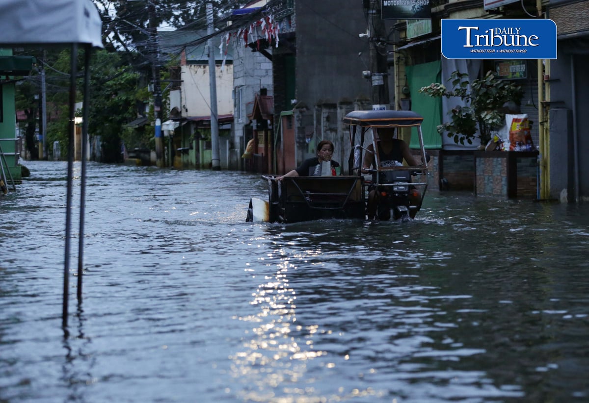 GEARING UP AGAINST FLOOD RISKS

Residents of Barangay San Juan in Hagonoy, Bulacan, wear protective gear while wading through floodwaters on Tuesday, 8 September 2026, in an effort to reduce their exposure to leptospirosis and other health risks.

The barangay has remained flooded for about a month due to persistent monsoon rains.

Photo by Analy Labor