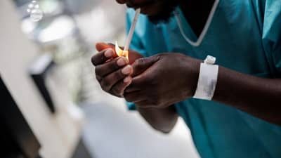 A PATIENT smokes in the enclosed smoking area of the Enhanced Psychiatric Emergency Centre part of the Delafontaine Hospital in Saint-Denis, north of Paris.