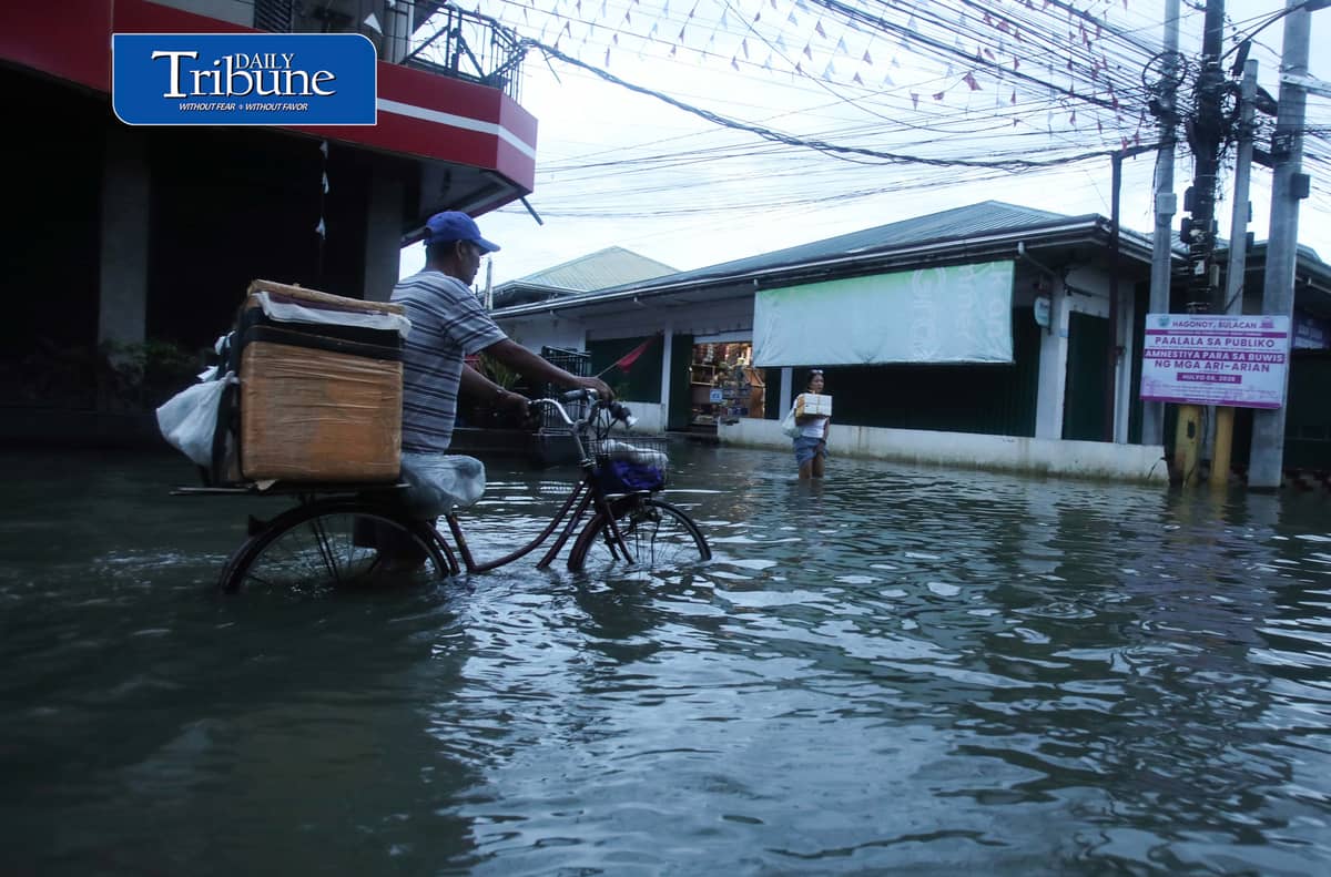GEARING UP AGAINST FLOOD RISKS

Residents of Barangay San Juan in Hagonoy, Bulacan, wear protective gear while wading through floodwaters on Tuesday, 8 September 2026, in an effort to reduce their exposure to leptospirosis and other health risks.

The barangay has remained flooded for about a month due to persistent monsoon rains.

Photo by Analy Labor