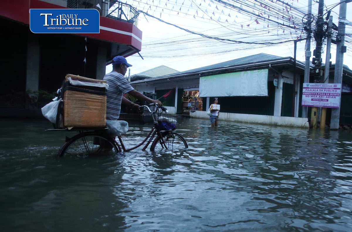 GEARING UP AGAINST FLOOD RISKS

Residents of Barangay San Juan in Hagonoy, Bulacan, wear protective gear while wading through floodwaters on Tuesday, 8 September 2026, in an effort to reduce their exposure to leptospirosis and other health risks.

The barangay has remained flooded for about a month due to persistent monsoon rains.

Photo by Analy Labor