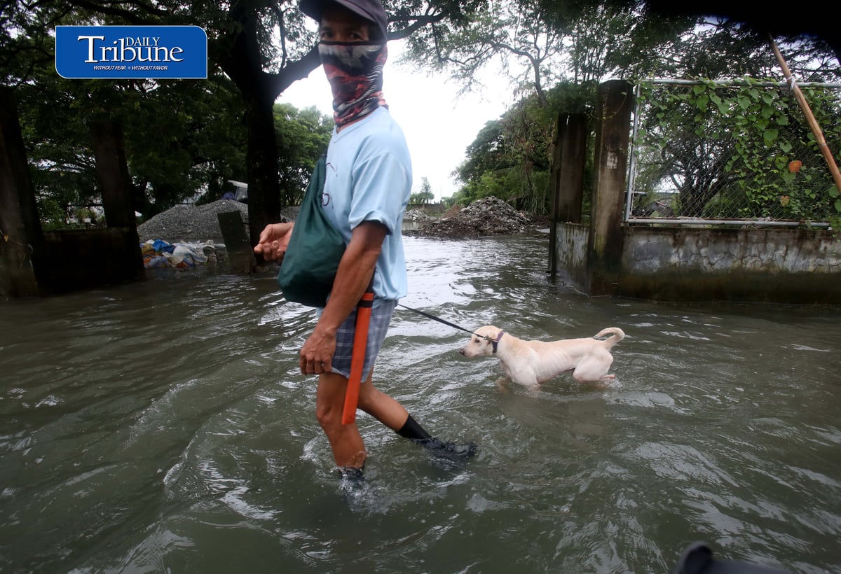 GEARING UP AGAINST FLOOD RISKS

Residents of Barangay San Juan in Hagonoy, Bulacan, wear protective gear while wading through floodwaters on Tuesday, 8 September 2026, in an effort to reduce their exposure to leptospirosis and other health risks.

The barangay has remained flooded for about a month due to persistent monsoon rains.

Photo by Analy Labor