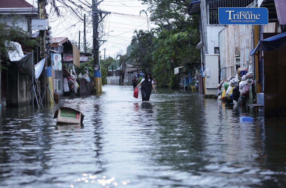 GEARING UP AGAINST FLOOD RISKS

Residents of Barangay San Juan in Hagonoy, Bulacan, wear protective gear while wading through floodwaters on Tuesday, 8 September 2026, in an effort to reduce their exposure to leptospirosis and other health risks.

The barangay has remained flooded for about a month due to persistent monsoon rains.

Photo by Analy Labor