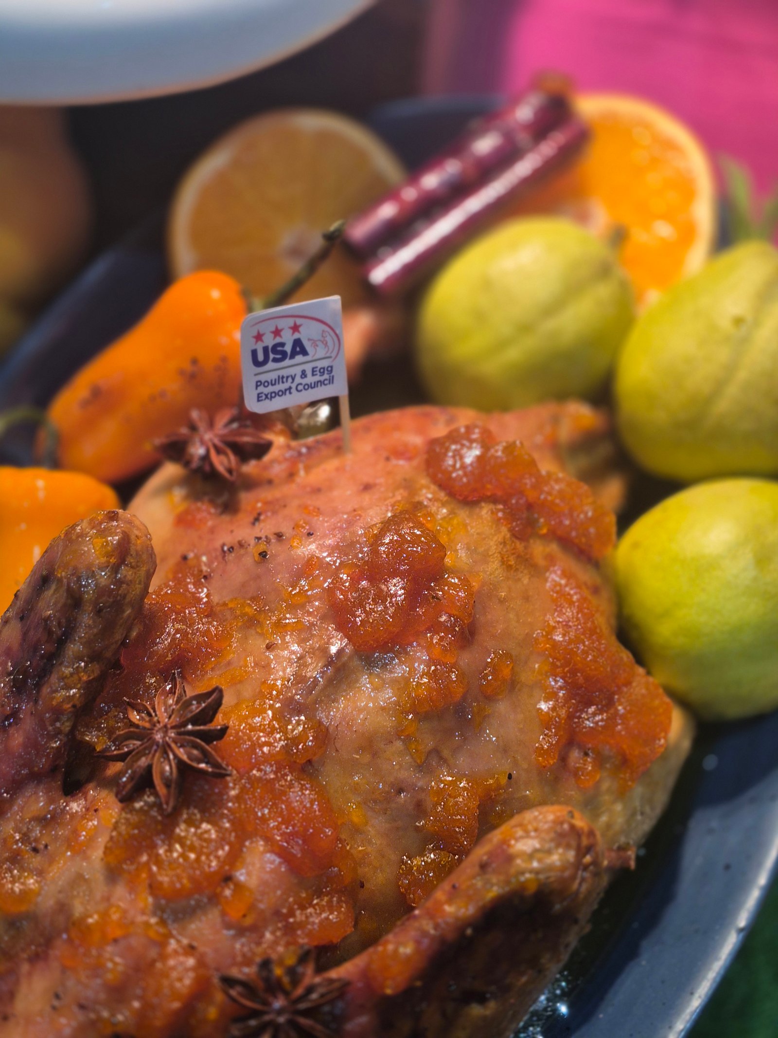 AN elevated fried chicken dish prepared alongside Chef Ivory Vaksman and another participant. The chicken is paired with a rich, savory sauce made with cream, macadamia nuts, pickled capers, rosemary and dried apples, with mashed potatoes and asparagus on the side.