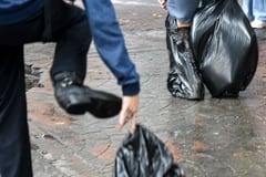 Commuters wear trash bags as makeshift protection