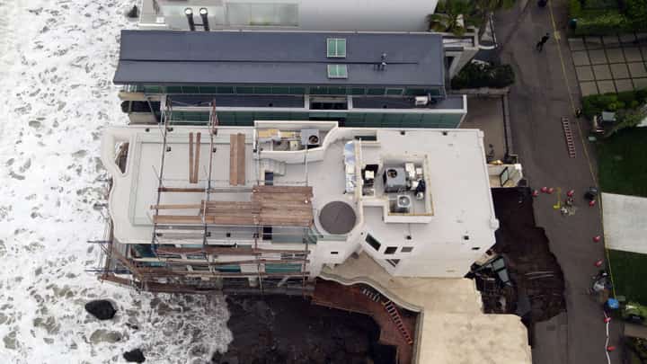 A SINKHOLE on a street and driveway of a seaside home affected by large swells produced by ‘Hurricane Marie’ in Malibu, California, on 8 September 2026.