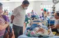 AN official from the local government of Albay in Bicol check on patients at a local hospital in the province.
