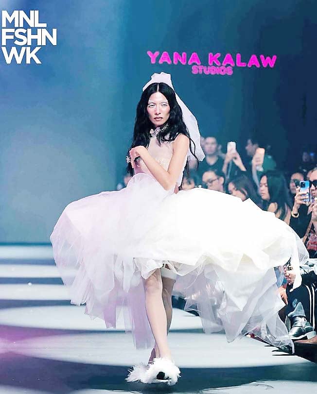 VOLUMNIOUS white tulle dress with a dramatic tiered skirt and matching veil.