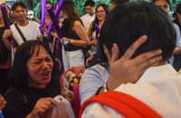 EXAMINEES turn emotional after completing the Bar examinations at the University of Santo Tomas in Manila on Sunday.