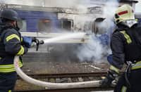 FIREFIGHTERS douse a train carriage damaged by a drone strike near Ukraine’s border with Poland on 13 September.