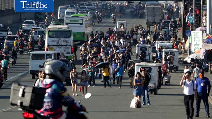 Commuters wait for available public transportation nearly 7 a.m. along Commonwealth Avenue in Quezon City on Monday morning, 14 September, as transport group MANIBELA begins the first day of its two-day strike.