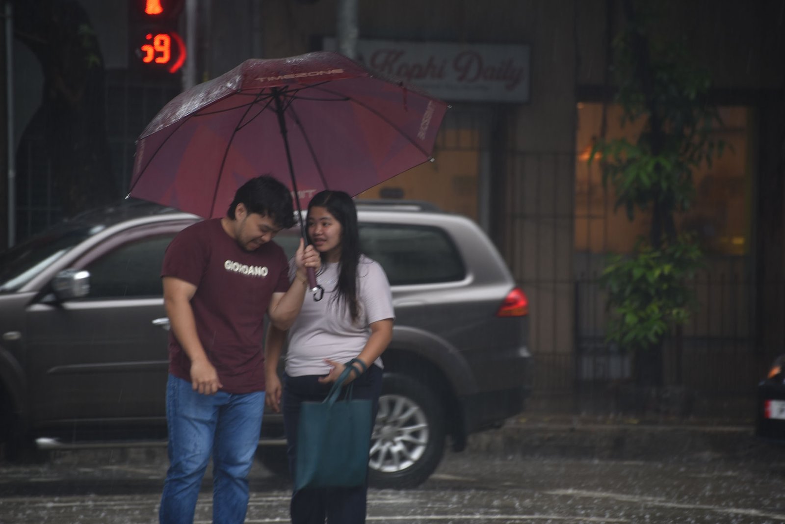Motorists and pedestrians brave through the heavy downpour brought by a thunderstorm in Manila, on September 15.