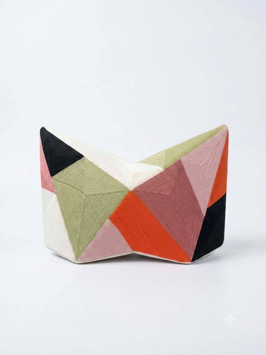 THE materials used for the Fractal Collision Star Clutch include handmade in the Philippines hand-laid 100 percent cotton thread detail, recycled PVC base.