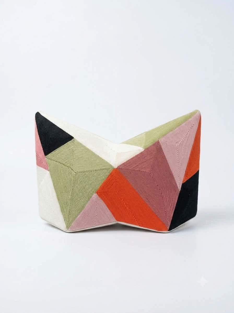 THE materials used for the Fractal Collision Star Clutch include handmade in the Philippines hand-laid 100 percent cotton thread detail, recycled PVC base.