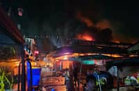 Flames and thick smoke rise over Pampanga Public Market in Angeles City as firefighters respond to a 4th‑alarm blaze early Thursday. Authorities confirm the fire has been contained, with operations still ongoing.