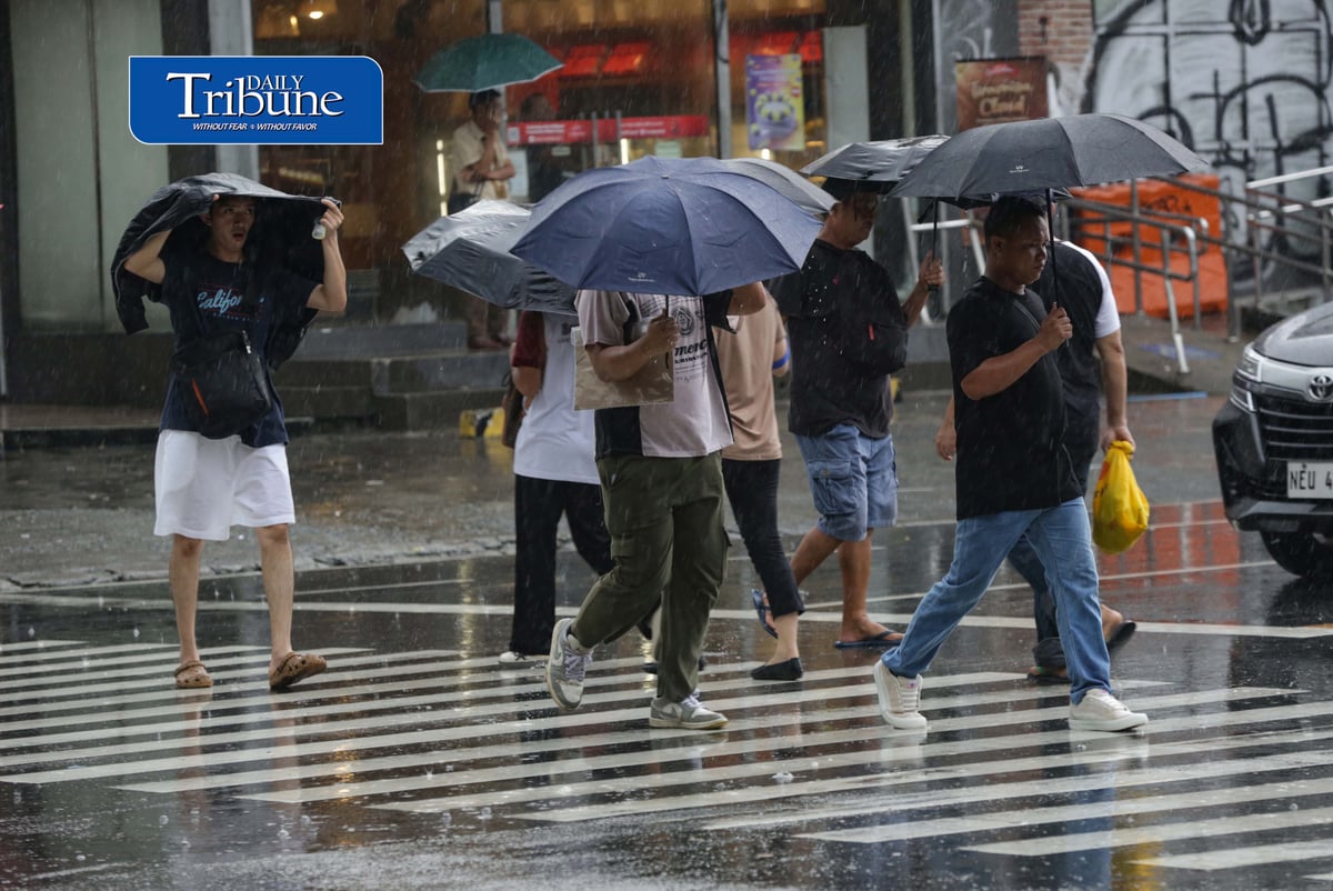 CAUGHT IN THE DOWNPOUR
Pedestrians use umbrellas and other makeshift covers to shield themselves from a sudden heavy downpour along EDSA in Quezon City on Friday, 18 September 2026. | Analy Labor
