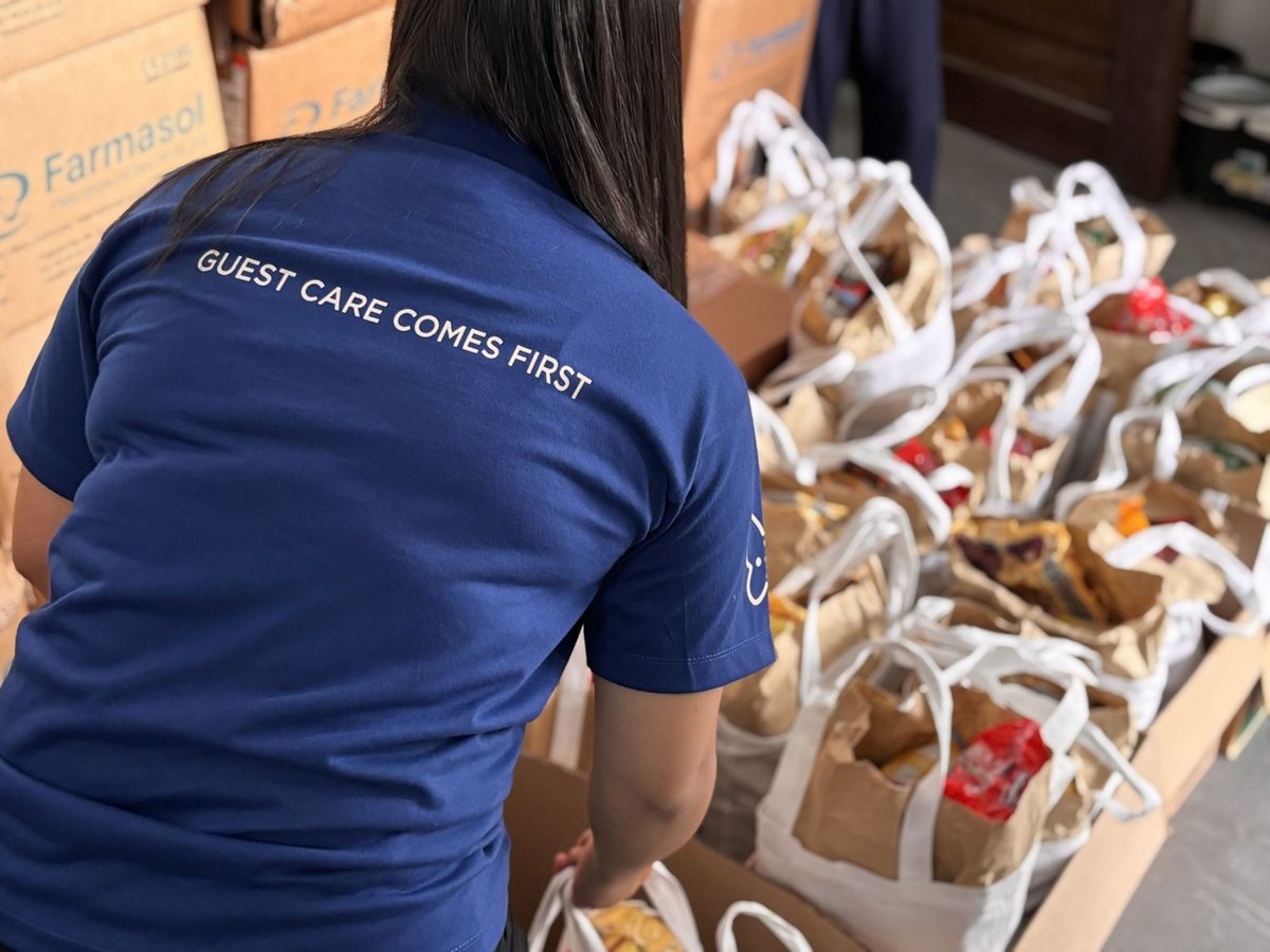 A NEPHROPLUS Philippines team member prepares grocery packs for distribution during the company’s kidney health medical mission.