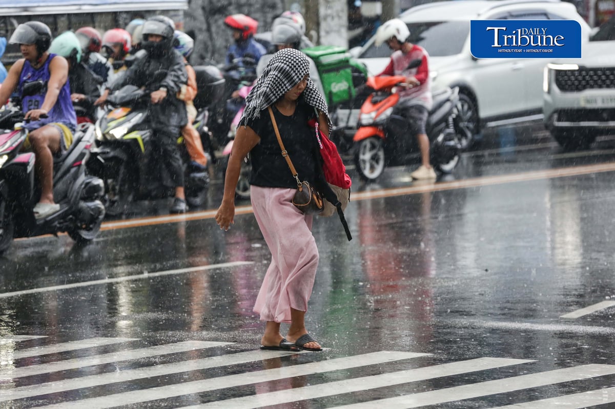 CAUGHT IN THE DOWNPOUR
Pedestrians use umbrellas and other makeshift covers to shield themselves from a sudden heavy downpour along EDSA in Quezon City on Friday, 18 September 2026. | Analy Labor