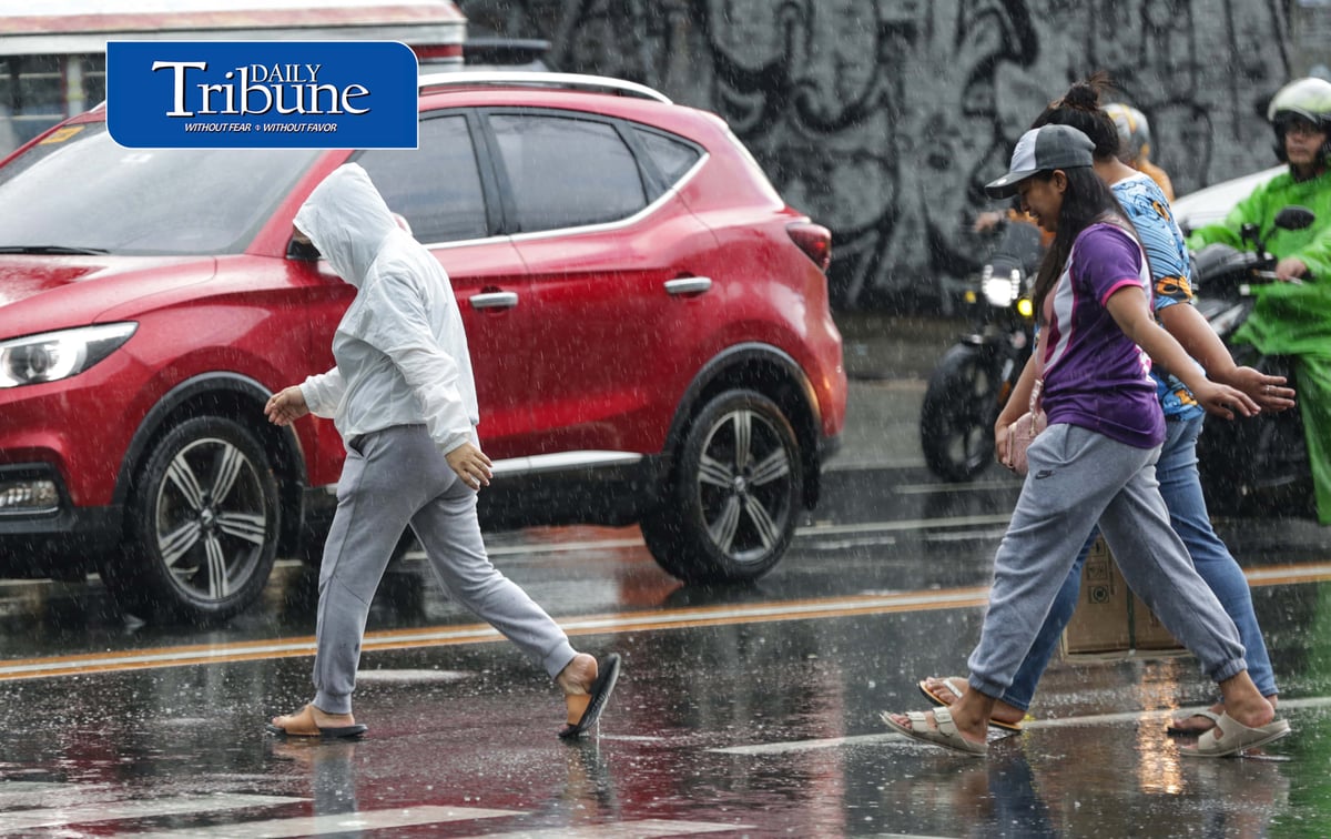 CAUGHT IN THE DOWNPOUR
Pedestrians use umbrellas and other makeshift covers to shield themselves from a sudden heavy downpour along EDSA in Quezon City on Friday, 18 September 2026. | Analy Labor