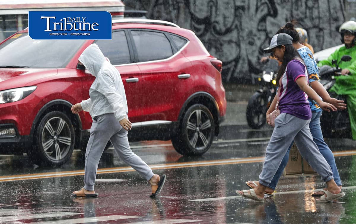 CAUGHT IN THE DOWNPOUR
Pedestrians use umbrellas and other makeshift covers to shield themselves from a sudden heavy downpour along EDSA in Quezon City on Friday, 18 September 2026. | Analy Labor