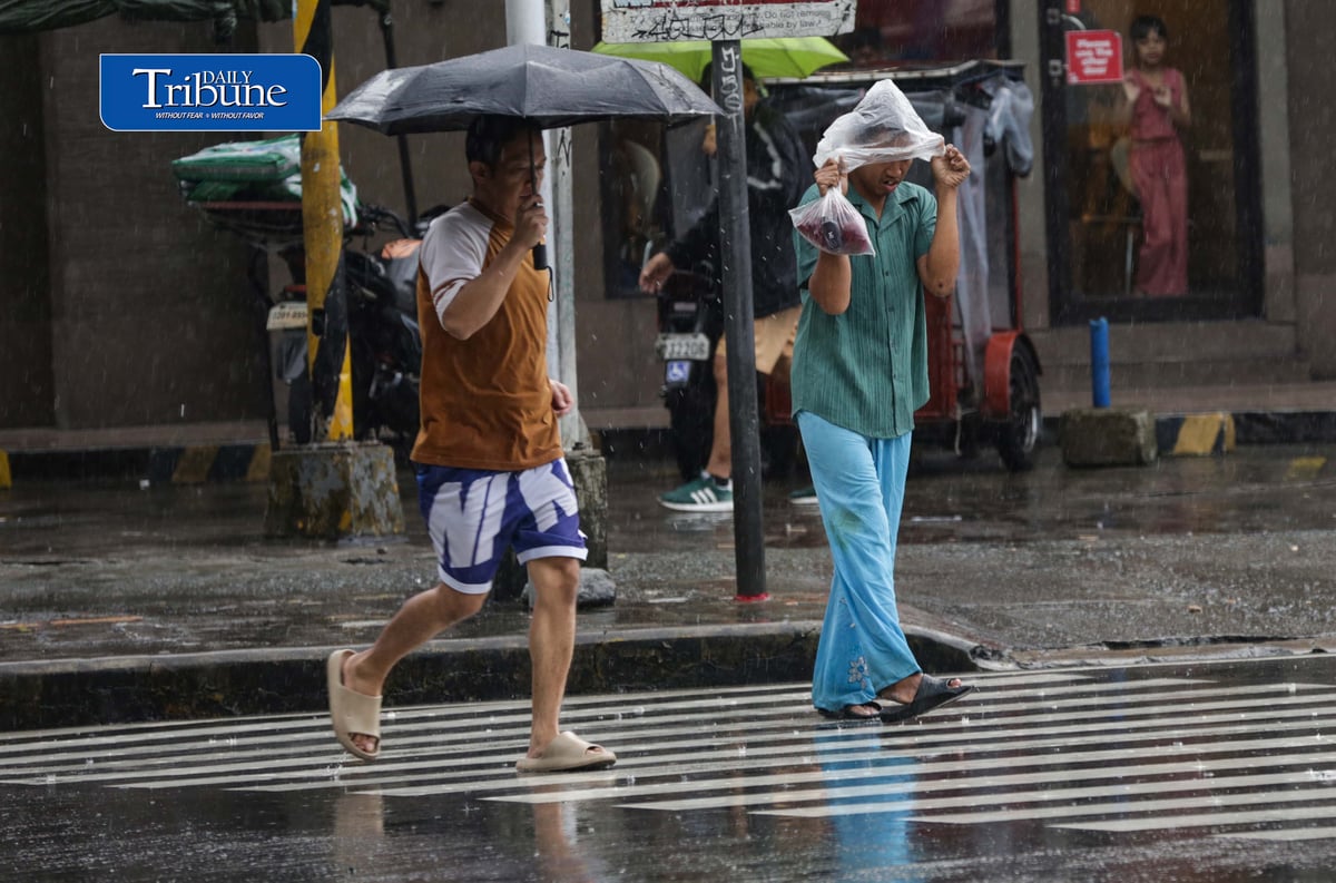 CAUGHT IN THE DOWNPOUR
Pedestrians use umbrellas and other makeshift covers to shield themselves from a sudden heavy downpour along EDSA in Quezon City on Friday, 18 September 2026. | Analy Labor