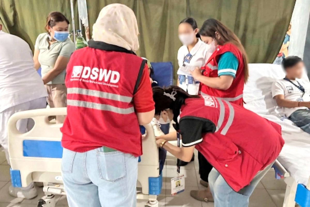 WORKERS from the Department of Social Welfare and Development tend to the students who were injured during the school shooting incident.