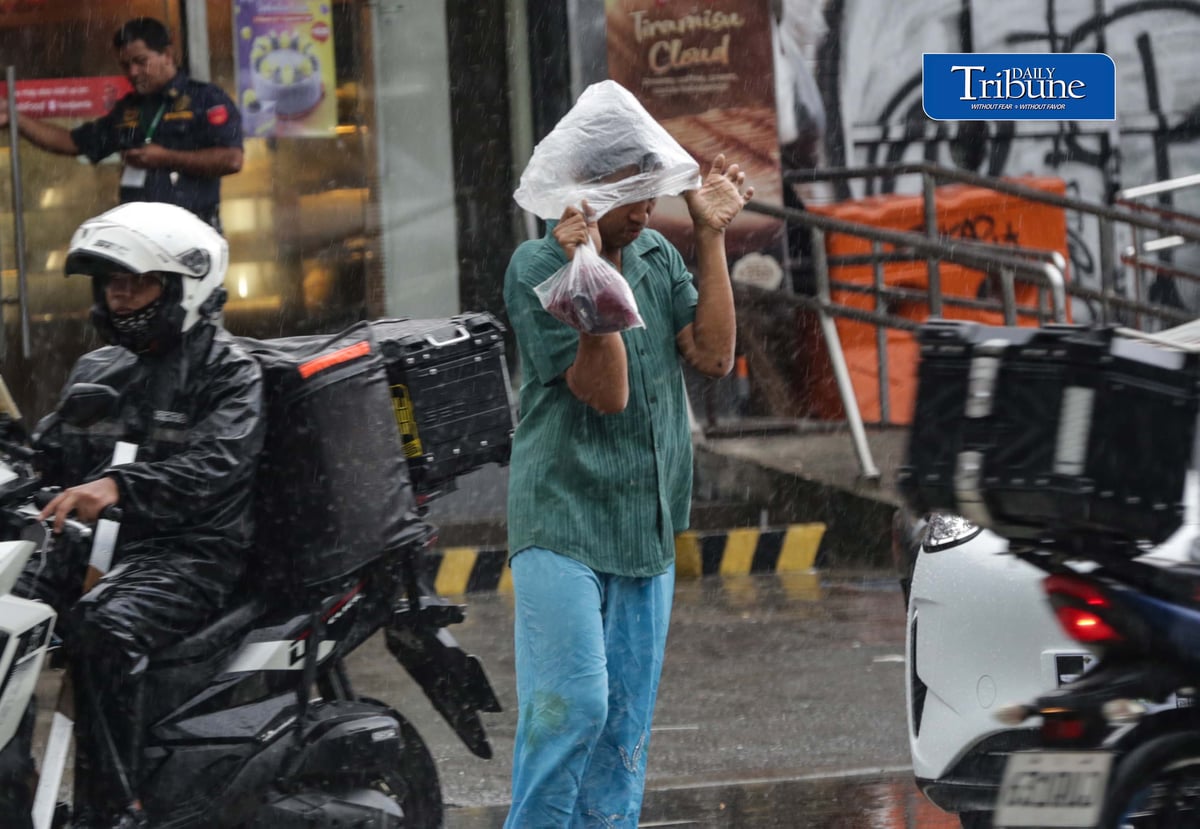 CAUGHT IN THE DOWNPOUR
Pedestrians use umbrellas and other makeshift covers to shield themselves from a sudden heavy downpour along EDSA in Quezon City on Friday, 18 September 2026. | Analy Labor