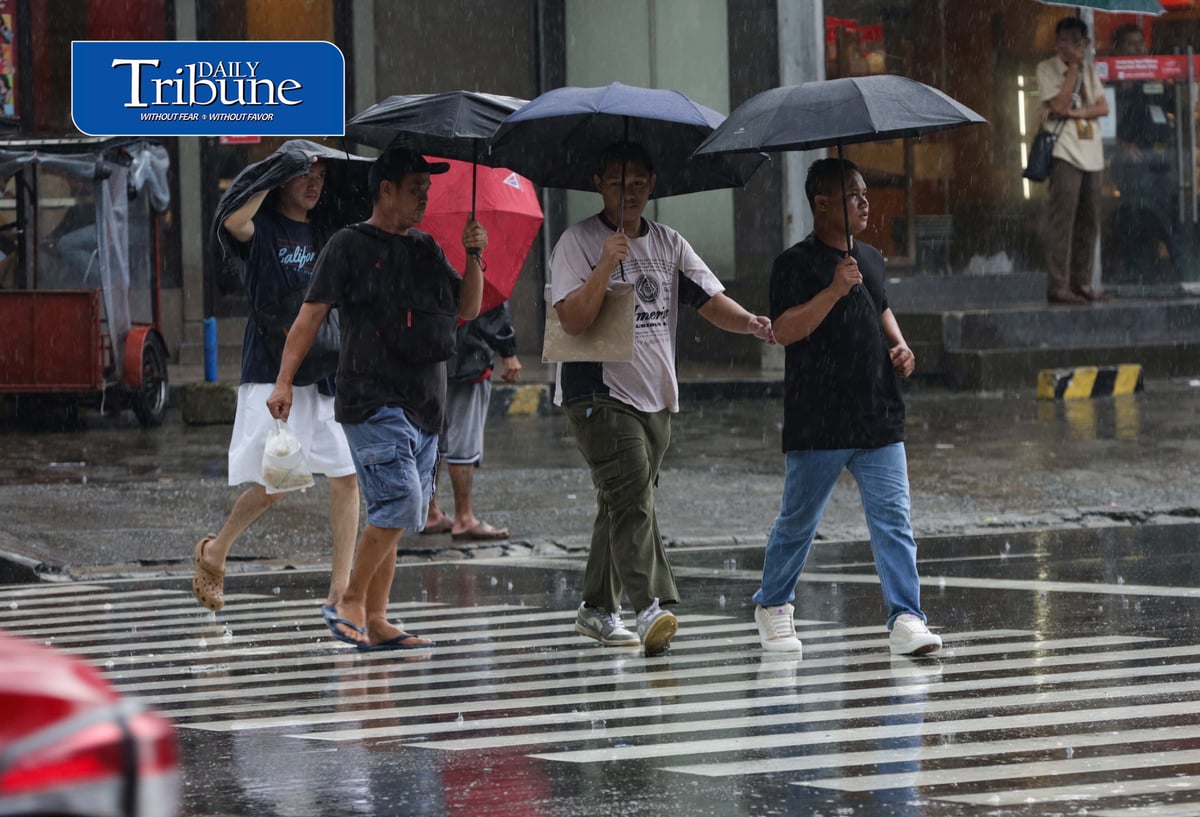 CAUGHT IN THE DOWNPOUR
Pedestrians use umbrellas and other makeshift covers to shield themselves from a sudden heavy downpour along EDSA in Quezon City on Friday, 18 September 2026. | Analy Labor