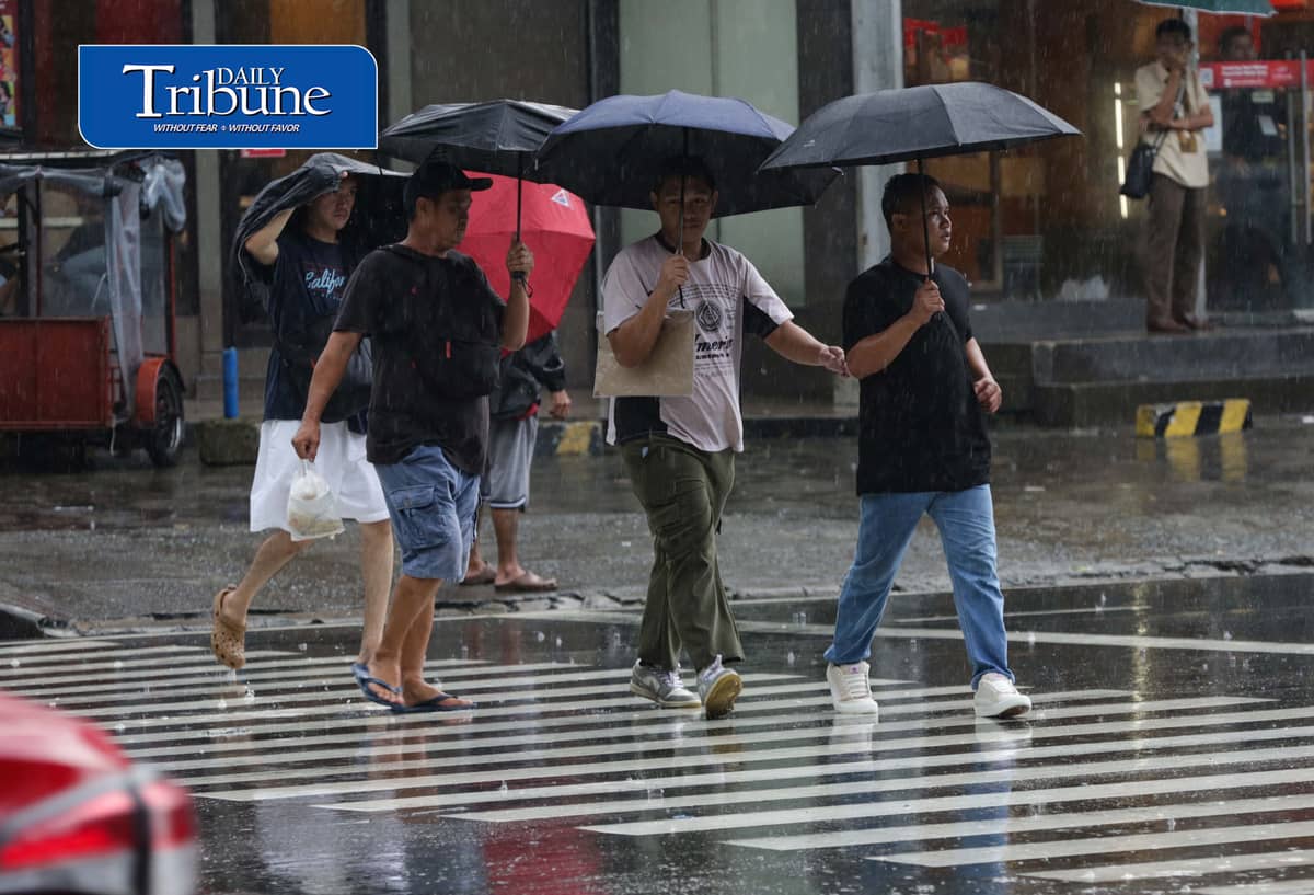 CAUGHT IN THE DOWNPOUR
Pedestrians use umbrellas and other makeshift covers to shield themselves from a sudden heavy downpour along EDSA in Quezon City on Friday, 18 September 2026. | Analy Labor