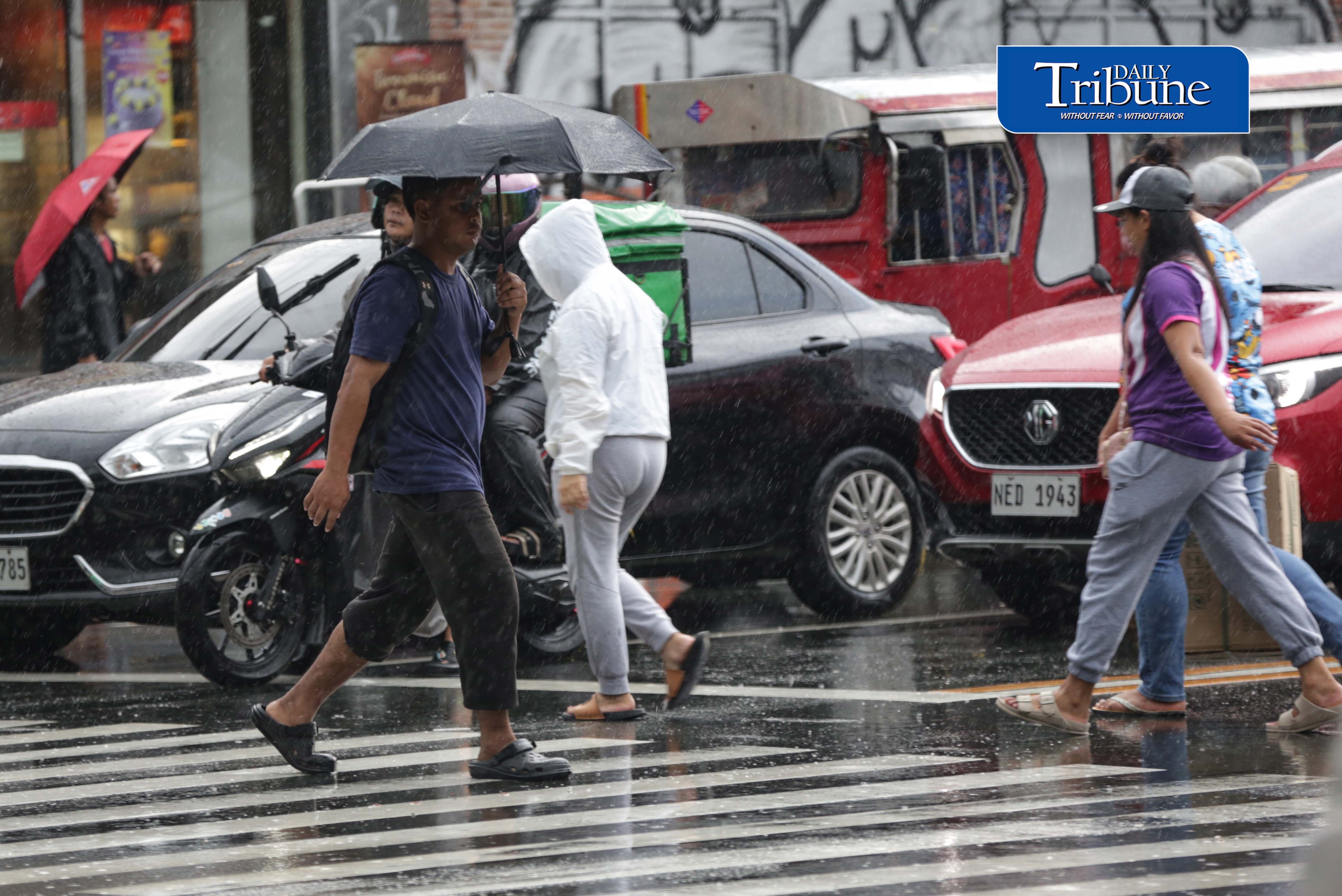 CAUGHT IN THE DOWNPOUR
Pedestrians use umbrellas and other makeshift covers to shield themselves from a sudden heavy downpour along EDSA in Quezon City on Friday, 18 September 2026. | Analy Labor
