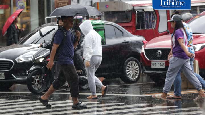 CAUGHT IN THE DOWNPOUR
Pedestrians use umbrellas and other makeshift covers to shield themselves from a sudden heavy downpour along EDSA in Quezon City on Friday, 18 September 2026. | Analy Labor