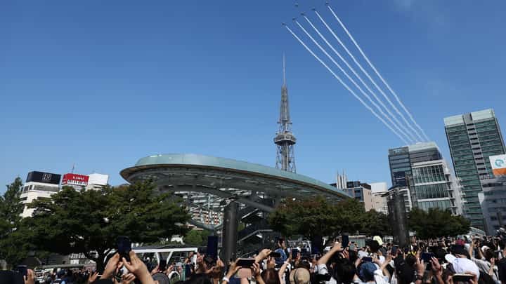 Kawasaki T-4s of the Japan Air Self-Defense Force's Blue Impulse aerobatic demonstration team perform a flypast ahead of the opening ceremony for the 2026 Asian Games in Nagoya on September 19, 2026.
